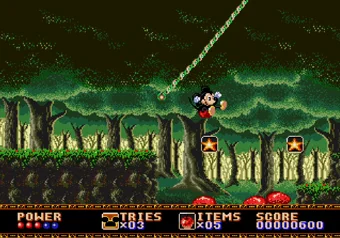 Mickey bouncing on enemies in Castle of Illusion Mickey Mouse mid-jump in Castle of Illusion